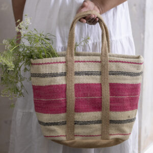 Handwoven jute basket bag with pink stripe detail. A stylish woven market and beach bag perfect for shopping, holidays, picnics and everyday essentials.