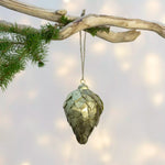 Large antique gold metal fir cone Christmas decoration with layered textured scales.