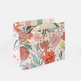 Large floral gift bag with hand-drawn pastel flowers and leaves, striped lining, fabric handles and matching gift tag.