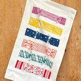Lottie Day Christmas Cracker tea towel hand-printed on 100% cotton with a festive cracker design.
