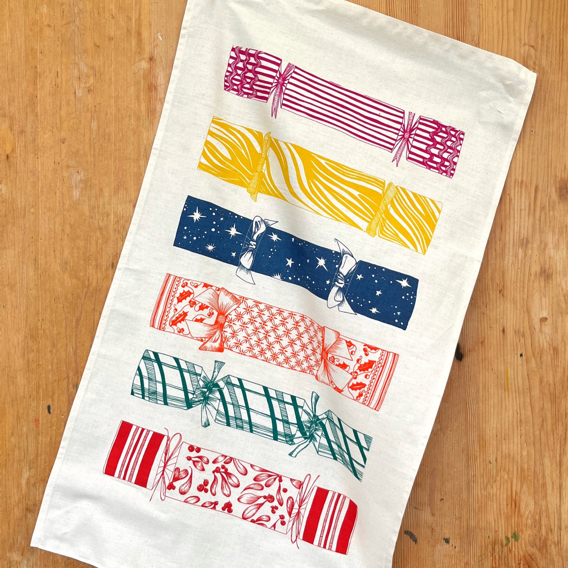 Lottie Day Christmas Cracker tea towel hand-printed on 100% cotton with a festive cracker design.