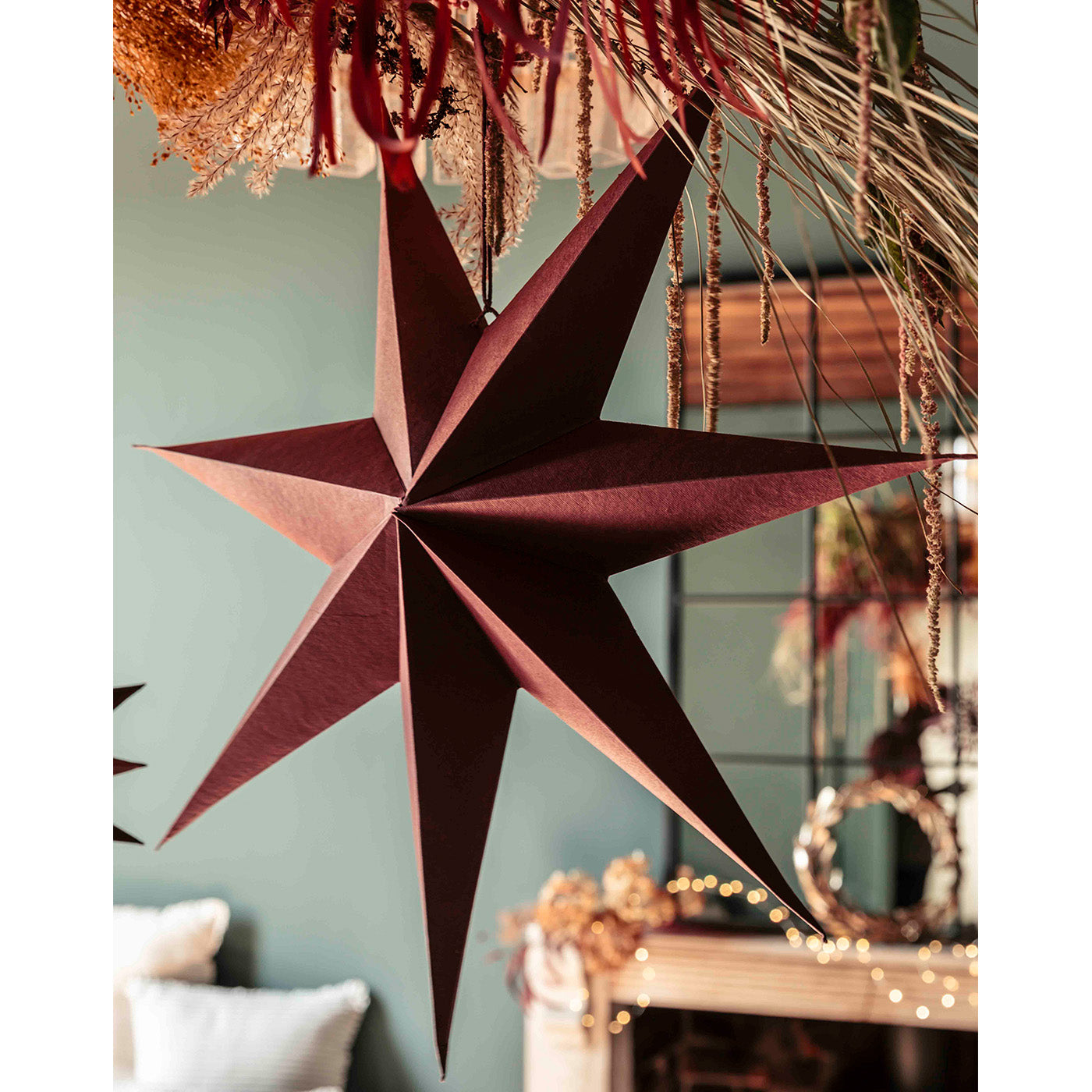 Maddox Berry Red seven-point paper Christmas star hanging decoration.