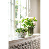 Green and white stoneware planter featuring foliage, fauna and butterfly motifs. A decorative plant pot perfect for houseplants and indoor styling.