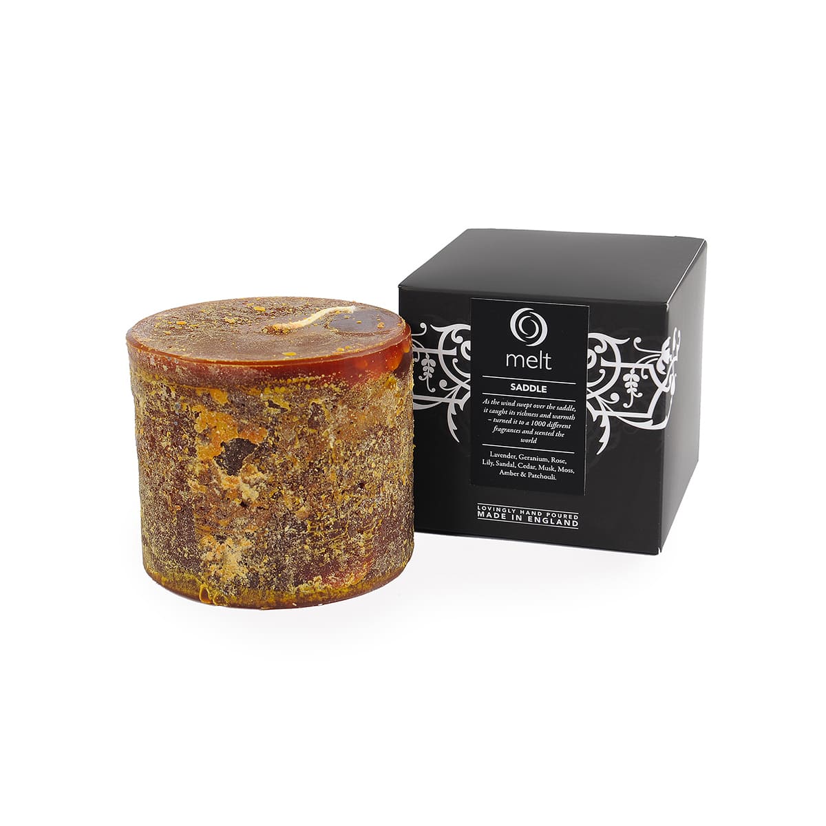 Melt Saddle scented pillar candle with warm sandalwood, cedar, amber and patchouli notes, styled as a luxury woody home fragrance candle.