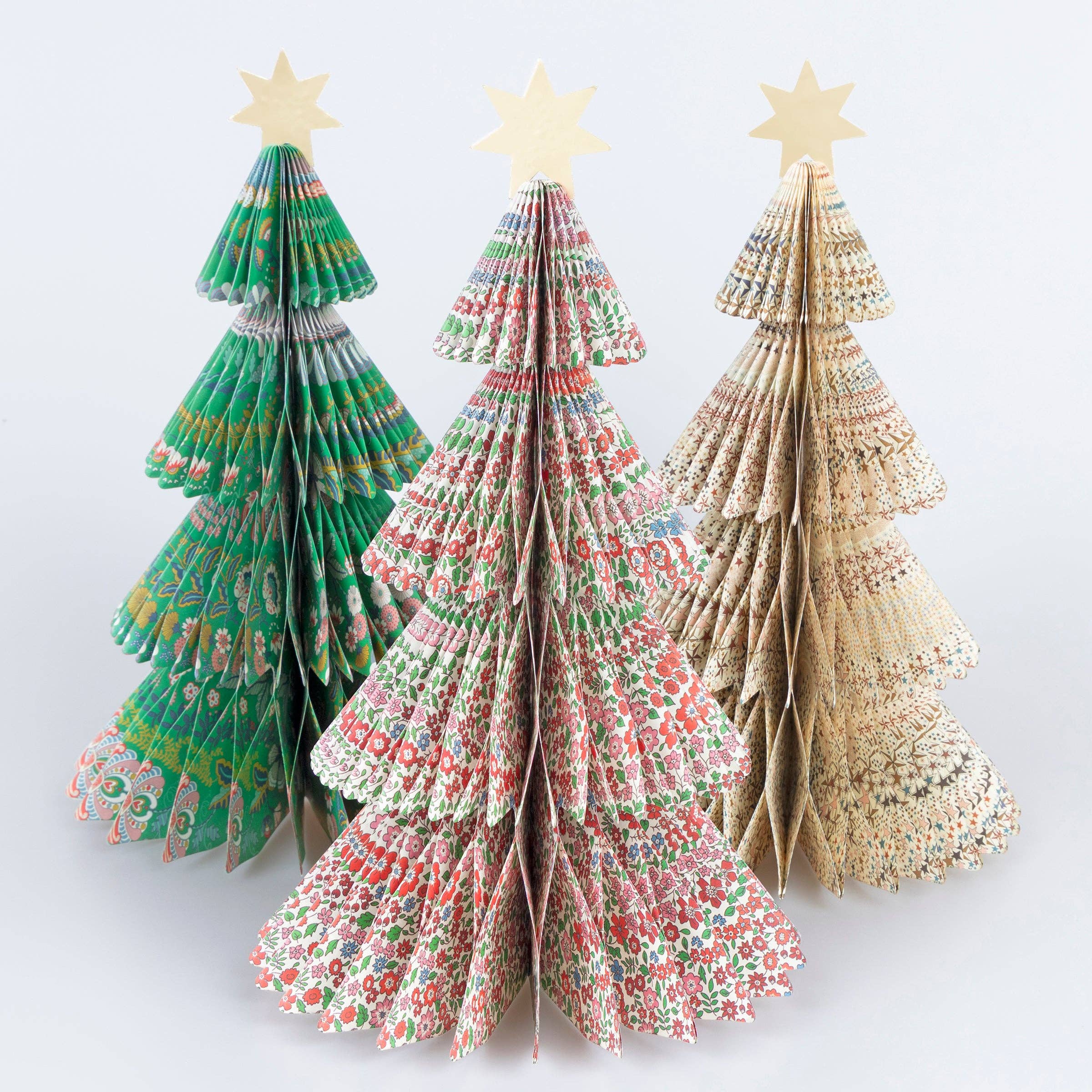 Shop Meri Meri x Liberty honeycomb Christmas trees. Set of 3 paper decorations in iconic Liberty prints, finished with metallic gold stars.