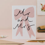 Mr and Mrs wedding card featuring an elegant bow and handwritten-style design.