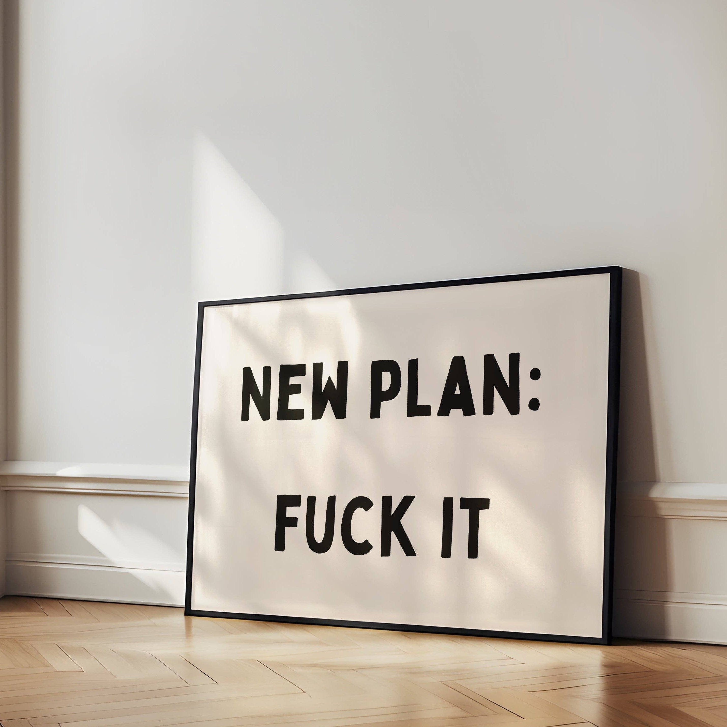 Bold black and cream typography wall art featuring the phrase ‘New Plan: Fuck It’. Premium giclée art print perfect for modern interiors and gallery walls.