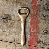 Nkuku Vintage Gold Bottle Opener crafted from solid metal with a warm vintage brass finish.