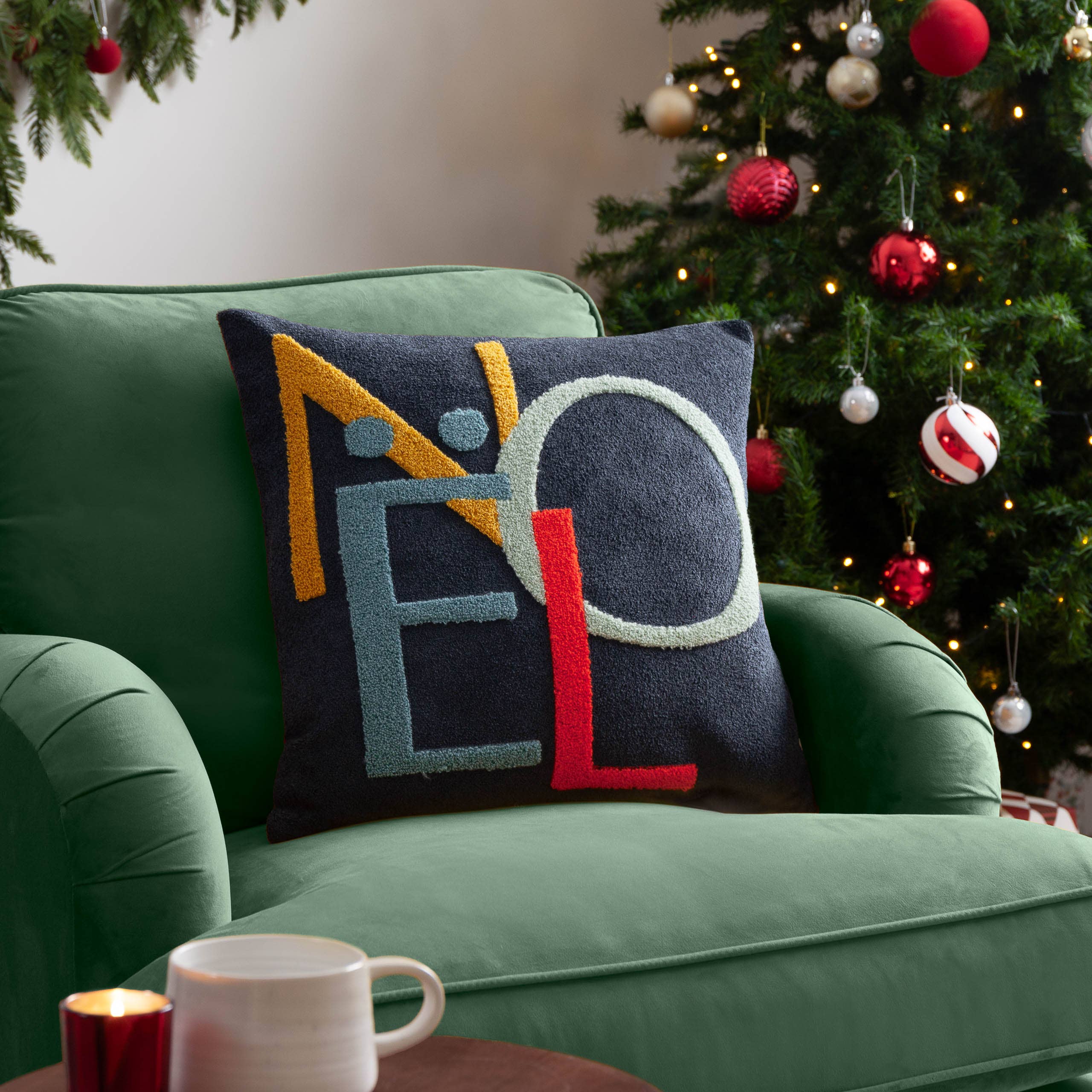 Multicoloured Noel Christmas cushion with embroidered tufted lettering