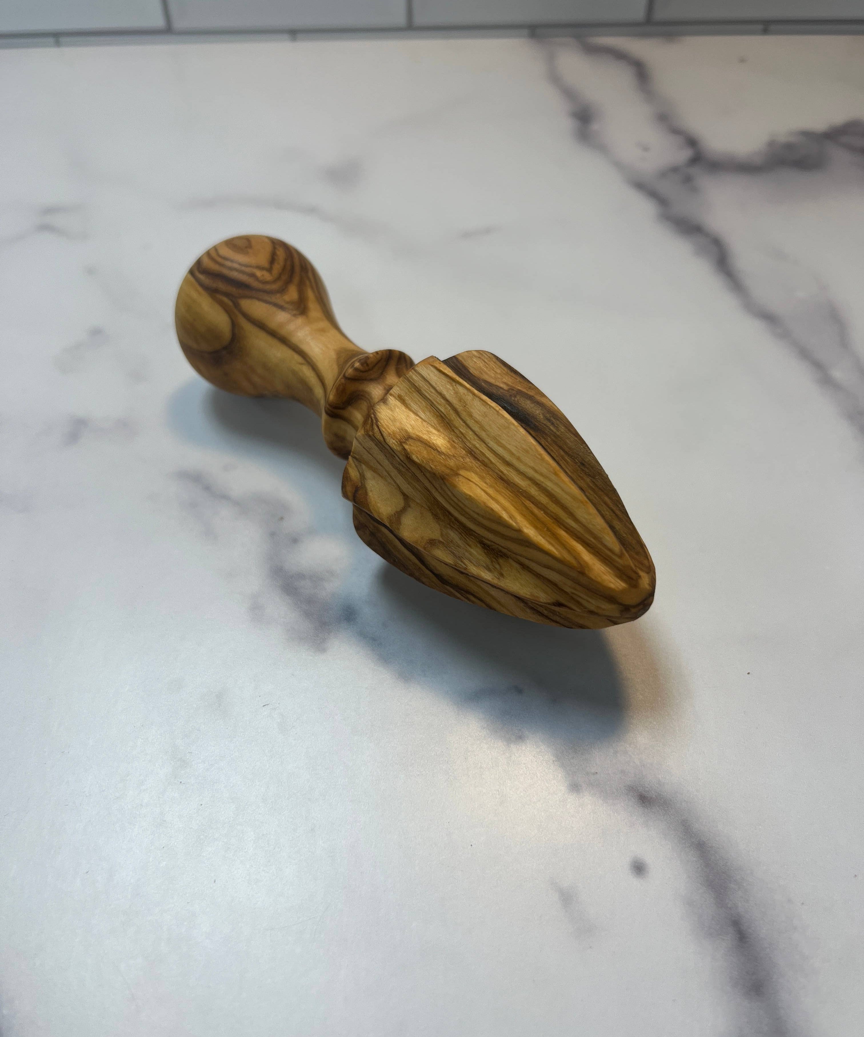 Shop olive wood citrus juicer. A natural wooden lemon squeezer perfect for everyday cooking, baking and kitchen styling.