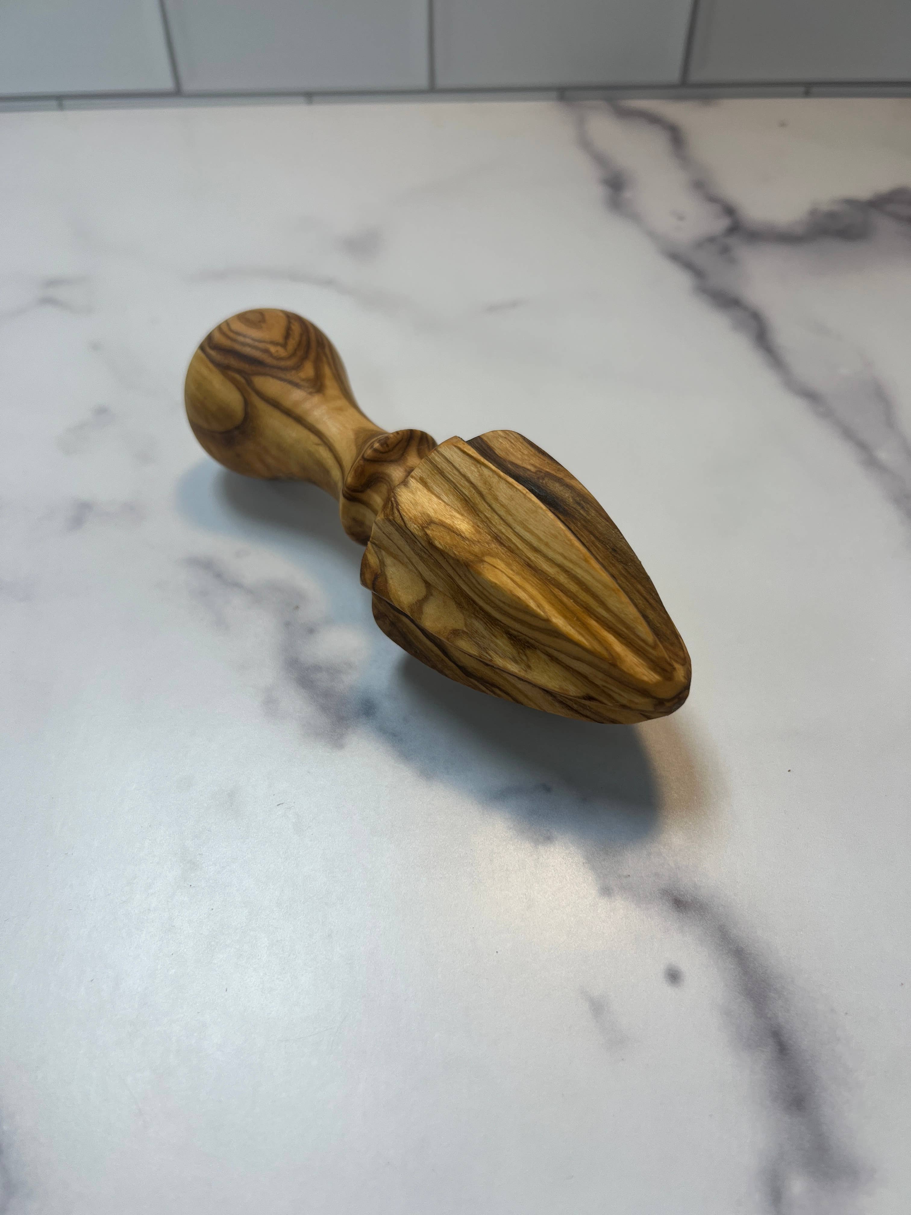 Shop olive wood citrus juicer. A natural wooden lemon squeezer perfect for everyday cooking, baking and kitchen styling.