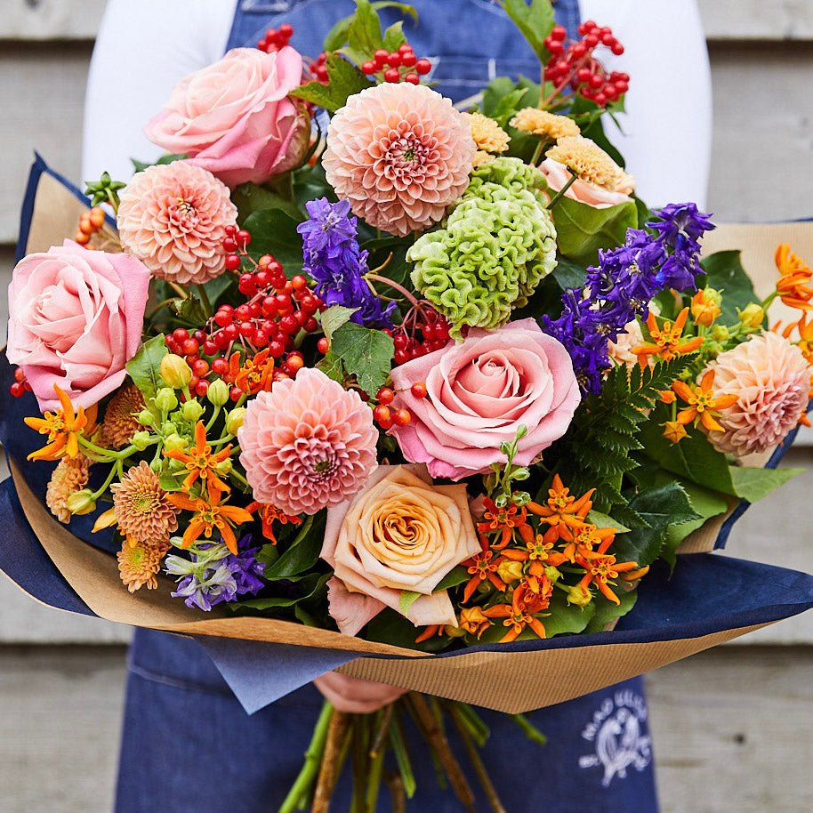 A colourful bouquet of dahlias, roses and complementing summer flowers.