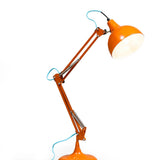 Stylish orange traditional desk lamp with contrasting blue fabric flex. A colourful statement table lamp for desks, bedrooms and cosy interiors.

