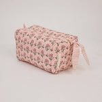 Handcrafted organic cotton toiletry bag with block-printed floral design, wipe-clean lining and internal pockets. Perfect for travel, skincare and beauty essentials.