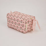 Handcrafted organic cotton toiletry bag with block-printed floral design, wipe-clean lining and internal pockets. Perfect for travel, skincare and beauty essentials.