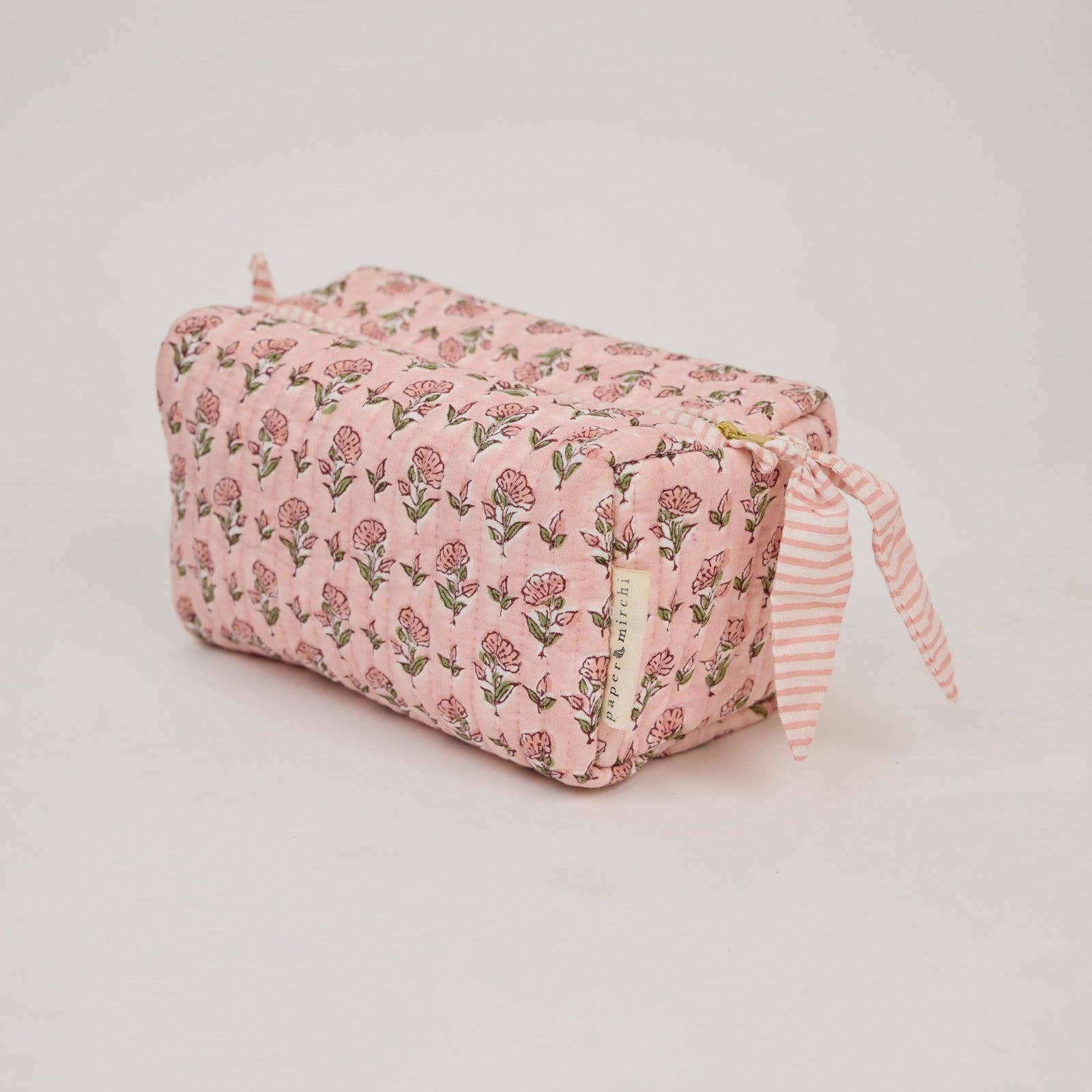 Handcrafted organic cotton toiletry bag with block-printed floral design, wipe-clean lining and internal pockets. Perfect for travel, skincare and beauty essentials.
