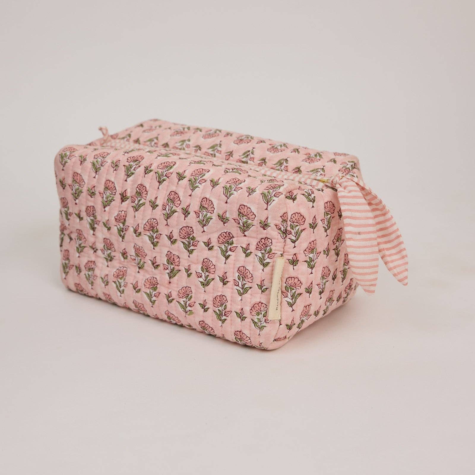 Handcrafted organic cotton toiletry bag with artisan block print design, wipe-clean lining and internal pockets. Beautiful quilted wash bag for travel and everyday use.