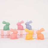Set of six pastel bunny-shaped candles in pink, mint, peach, blue, lilac and yellow with matching coloured wicks.