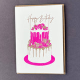 Penguin Ink Birthday Cake letterpress birthday card featuring a neon red two-tier cake, metallic gold details and Happy Birthday calligraphy.