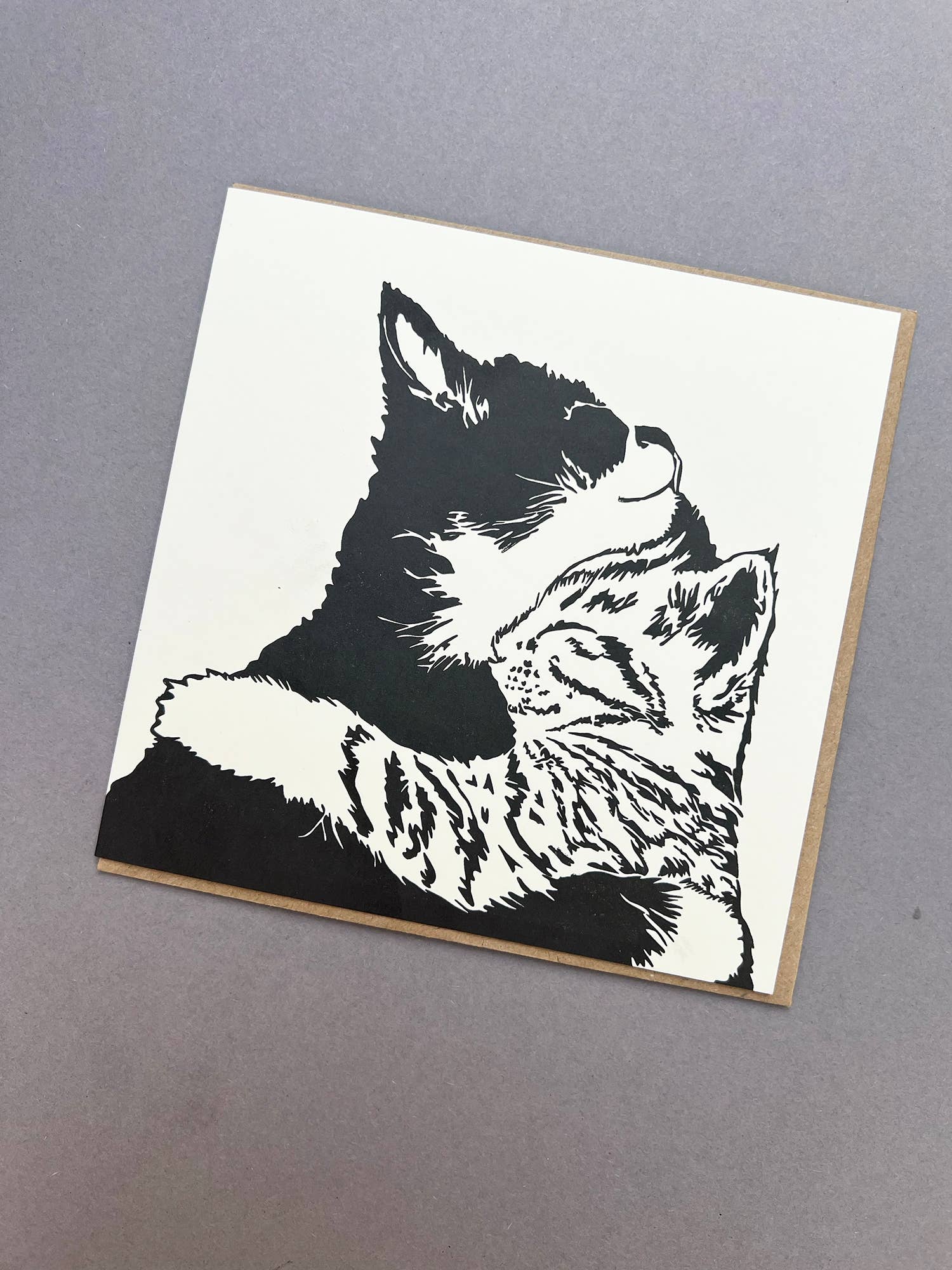 Penguin Ink Cuddle Time letterpress greeting card featuring two cuddling kittens, printed on 100% recycled board with a tactile embossed finish.