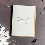 Penguin Ink mini Thank You letterpress greeting card featuring elegant black modern calligraphy printed on thick recycled card.