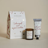 Plum & Ashby Cedarwood & Pine Needles Christmas gift set containing a scented votive candle and matching nourishing hand cream in a presentation box.