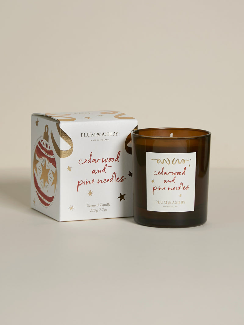 Plum & Ashby Cedarwood & Pine Needles 220g Christmas scented soy candle in a recyclable glass vessel with illustrated festive gift box.