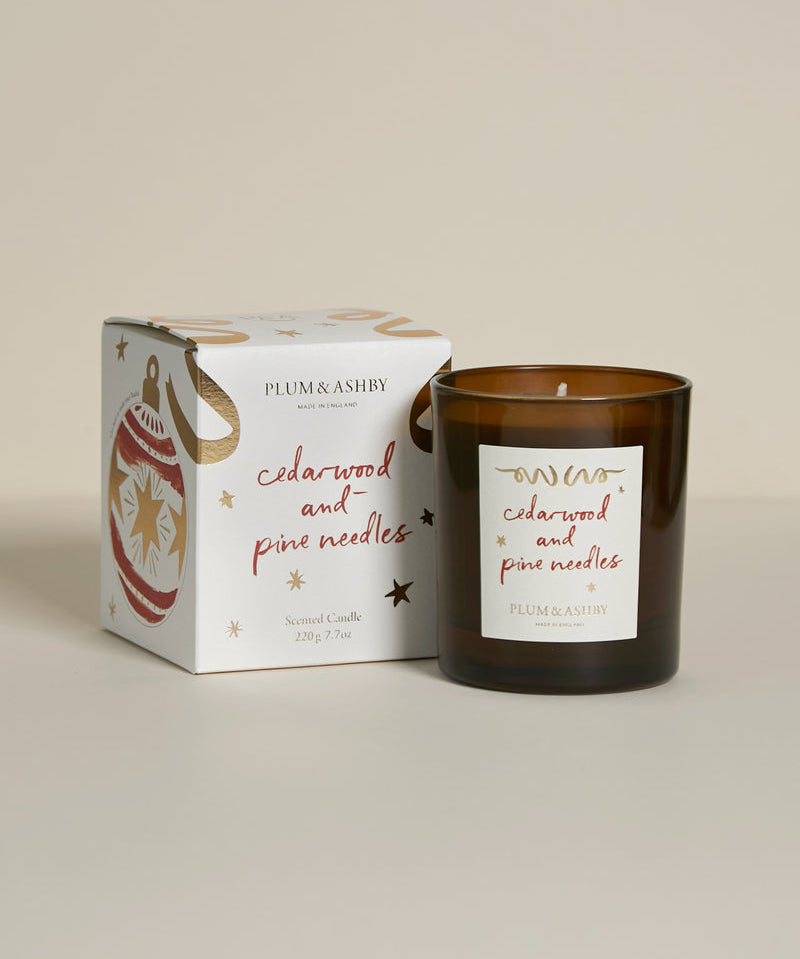 Plum & Ashby Cedarwood & Pine Needles 220g Christmas scented soy candle in a recyclable glass vessel with illustrated festive gift box.