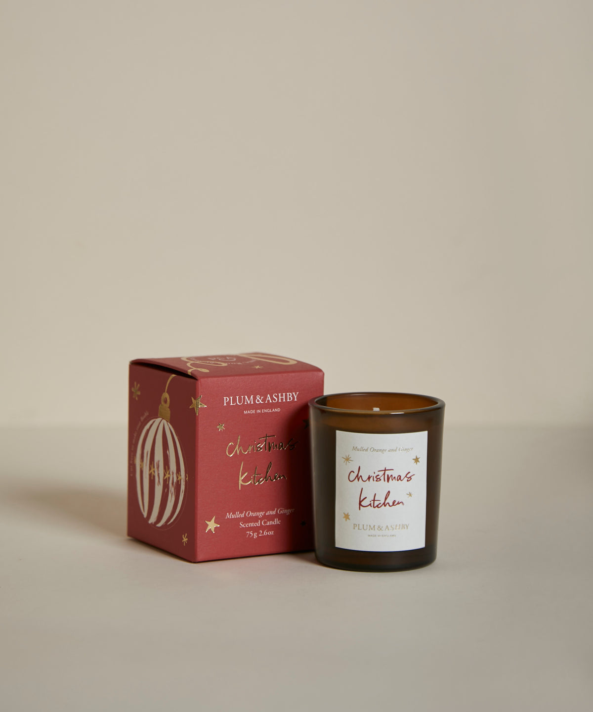 Plum & Ashby Christmas Kitchen Votive Candle in Mulled Orange & Ginger fragrance, hand-poured in signature amber glass.