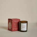 Plum & Ashby Christmas Kitchen Votive Candle in Mulled Orange & Ginger fragrance, hand-poured in signature amber glass.
