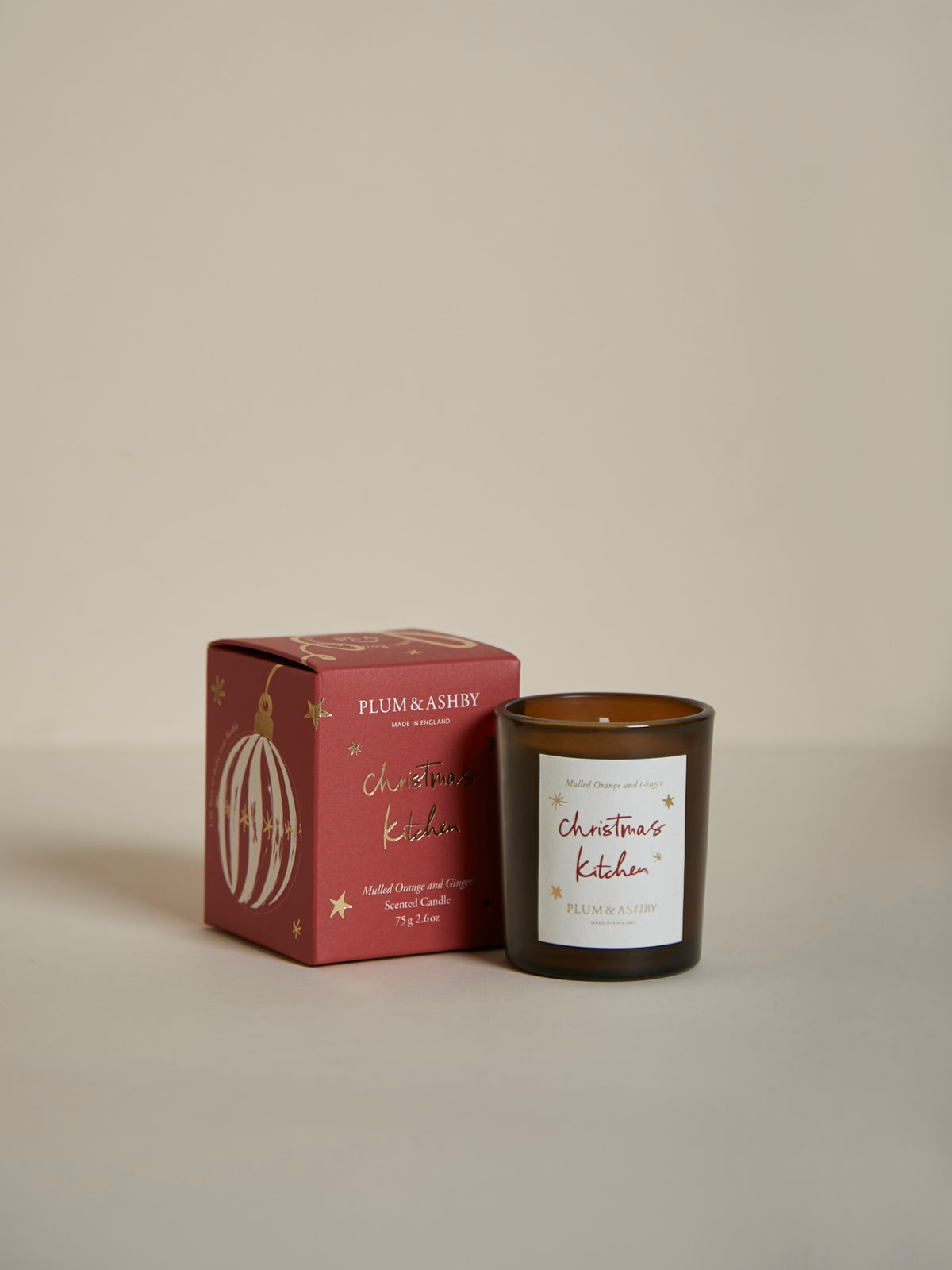 Plum & Ashby Christmas Kitchen Votive Candle in Mulled Orange & Ginger fragrance, hand-poured in signature amber glass.