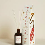 Plum & Ashby Festive Spice & Clementine Christmas reed diffuser with illustrated festive gift box featuring reusable Christmas bauble decorations.