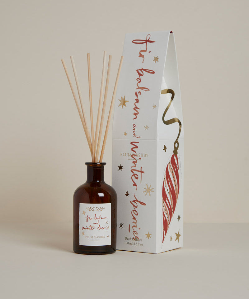 Fir Balsam & Winter Berries Reed Diffuser in a recyclable glass bottle with natural reeds. A luxury Christmas home fragrance with fir needle, winter berries, cinnamon, cedarwood and amber, offering continuous festive scent for up to 8 weeks.