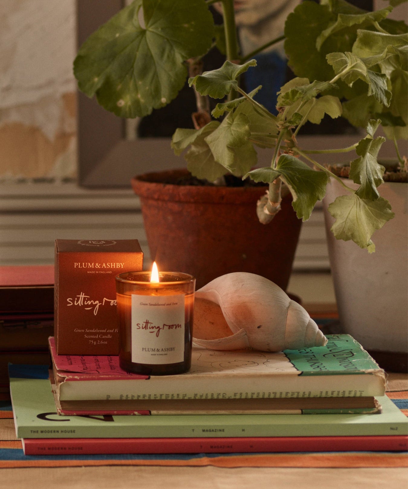 Plum & Ashby Sitting Room Votive Candle – Green Sandalwood & Fern in a recyclable glass vessel. A hand-poured natural soy wax candle with fresh violet leaf, lily of the valley, green sandalwood, vetiver and fern, designed to create a warm, calming living space.