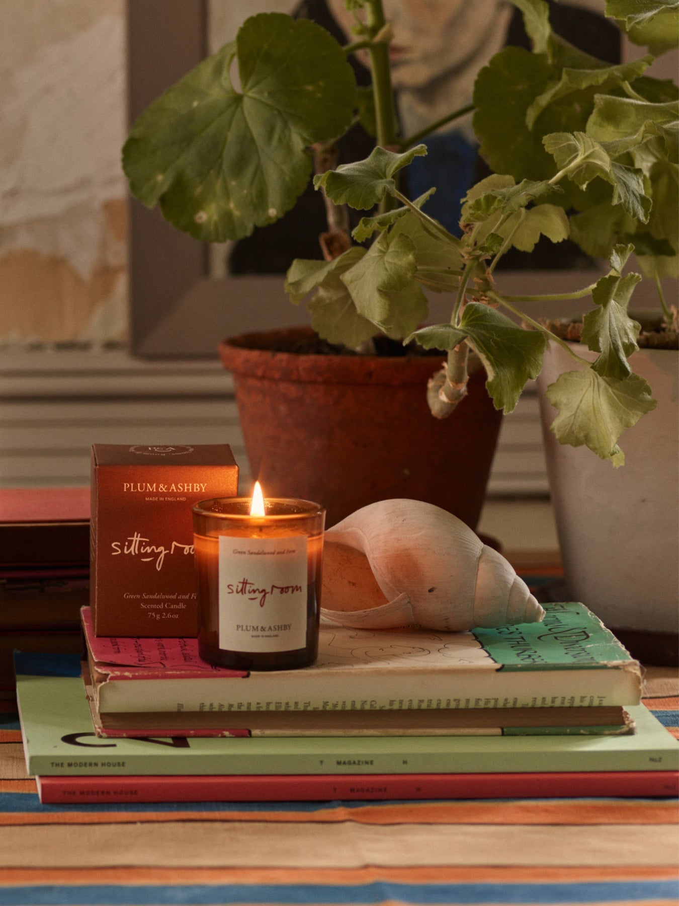 Plum & Ashby Sitting Room Votive Candle – Green Sandalwood & Fern in a recyclable glass vessel. A hand-poured natural soy wax candle with fresh violet leaf, lily of the valley, green sandalwood, vetiver and fern, designed to create a warm, calming living space.