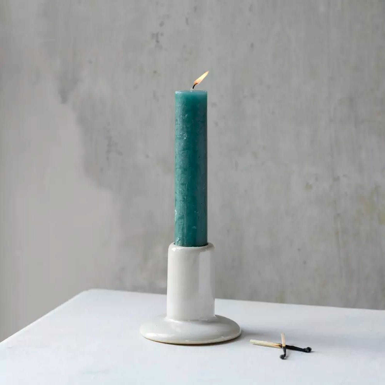 Elegant white ceramic candle holder with a textured finish and timeless cylindrical shape. Perfect for dinner candles, tablescapes and cosy interiors.