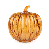 Pumpkin-shaped orange glass LED table lamp creating a warm ambient glow for autumn, harvest and Halloween home décor.