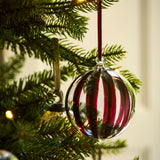 Large clear glass Christmas baubles with hand-painted berry red and gold stripes and velvet ribbons