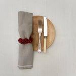 Red berry wooden bead Christmas napkin ring on a table setting