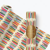Rifle Paper Co. Candle Gift Wrap featuring colourful illustrated candles with gold foil accents on a decorative wrapping paper roll.
