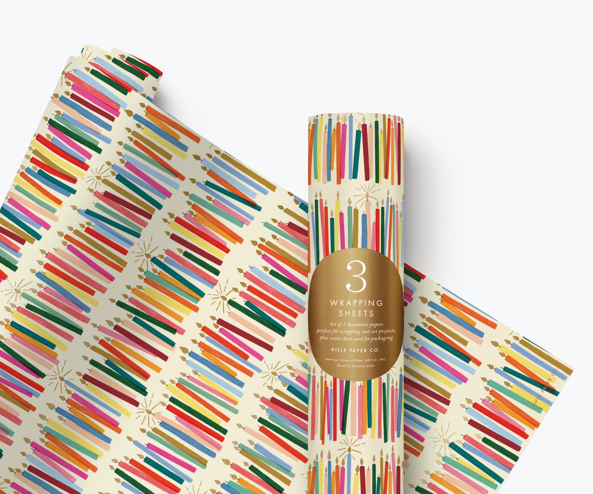 Rifle Paper Co. Candle Gift Wrap featuring colourful illustrated candles with gold foil accents on a decorative wrapping paper roll.