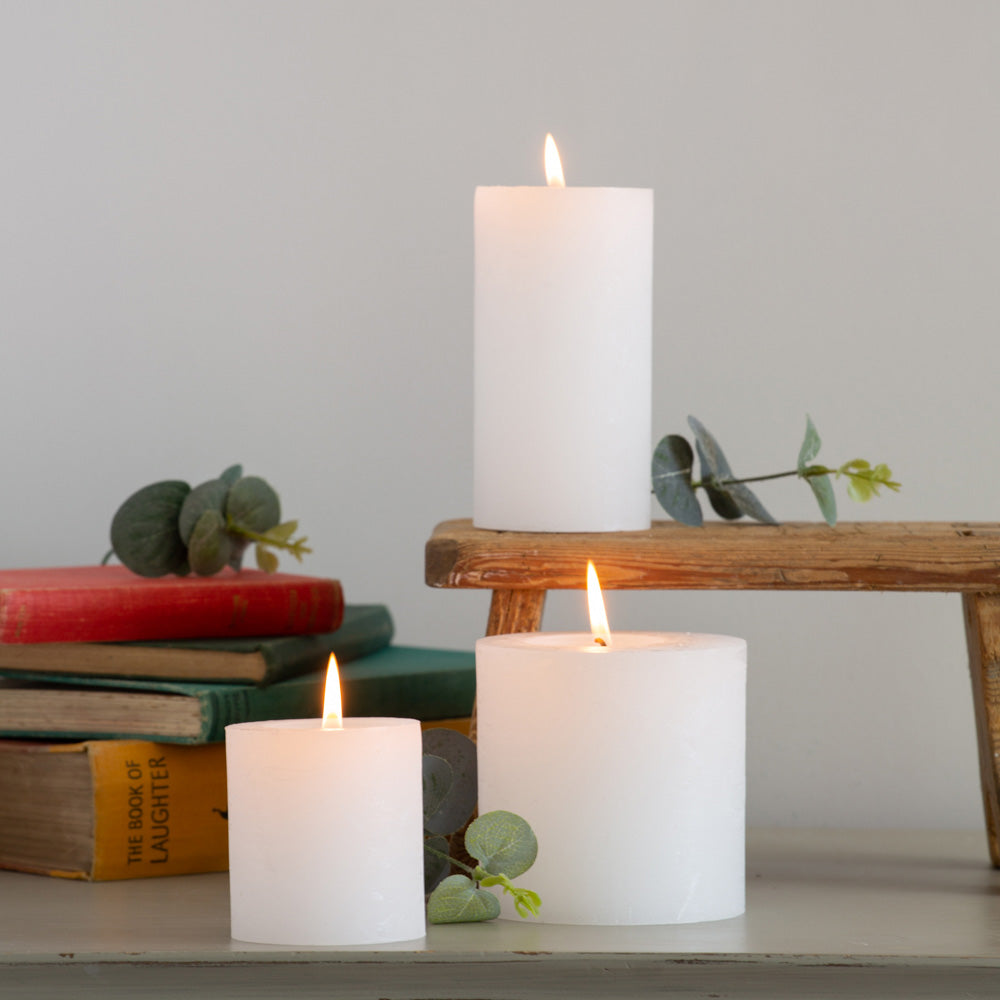 Classic white rustic pillar candle with a textured finish and warm even burn. Available in 3 sizes for tablescapes, cosy interiors and elegant home styling.