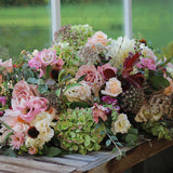 Natural garden-style casket spray funeral flowers featuring seasonal blooms and foliage, handcrafted by Mad Lilies florists in Banstead, Surrey.