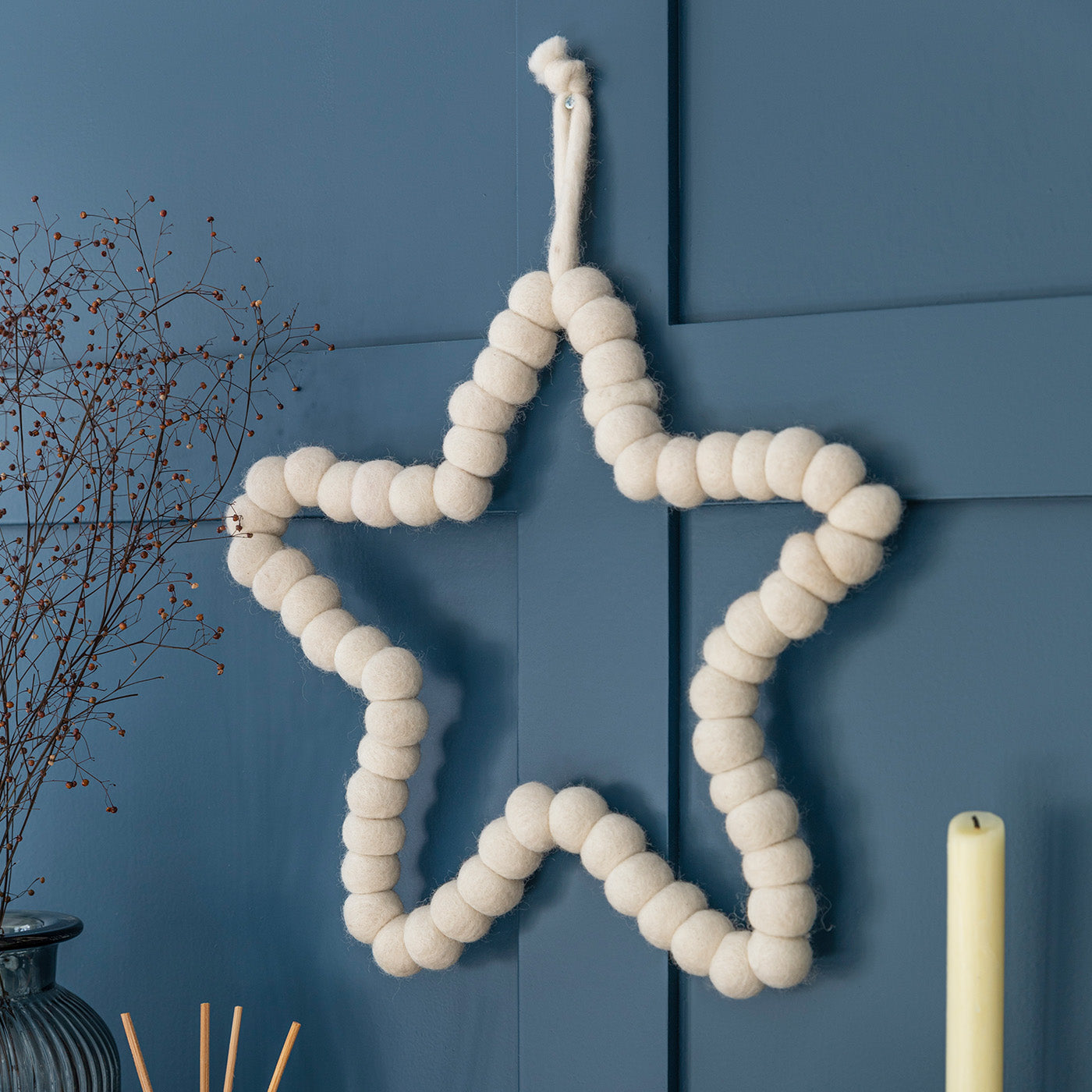 Southwold Warm White Felt Christmas Star handmade from 100% sheep wool.
35cm Warm White wool felt star decoration with soft pom pom detailing.