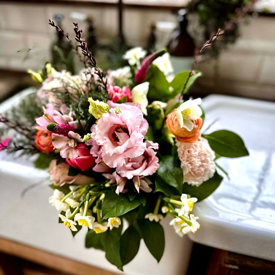 Small hand-tied summer flowers posy featuring seasonal blooms and foliage arranged in a natural garden-inspired style.
