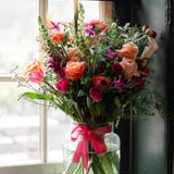 Summer Showstopper Vase with premium roses arranged in a glass apothecary vase