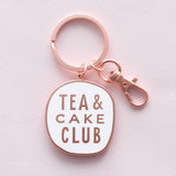 Keychain with 'Tea & Cake Club' text on a light pink background
