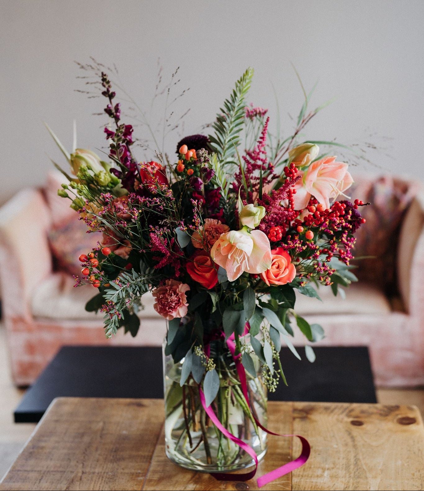 The Christmas Showstopper luxury Christmas flower vase arrangement featuring abundant seasonal flowers and festive winter foliage, handcrafted by Mad Lilies florists.