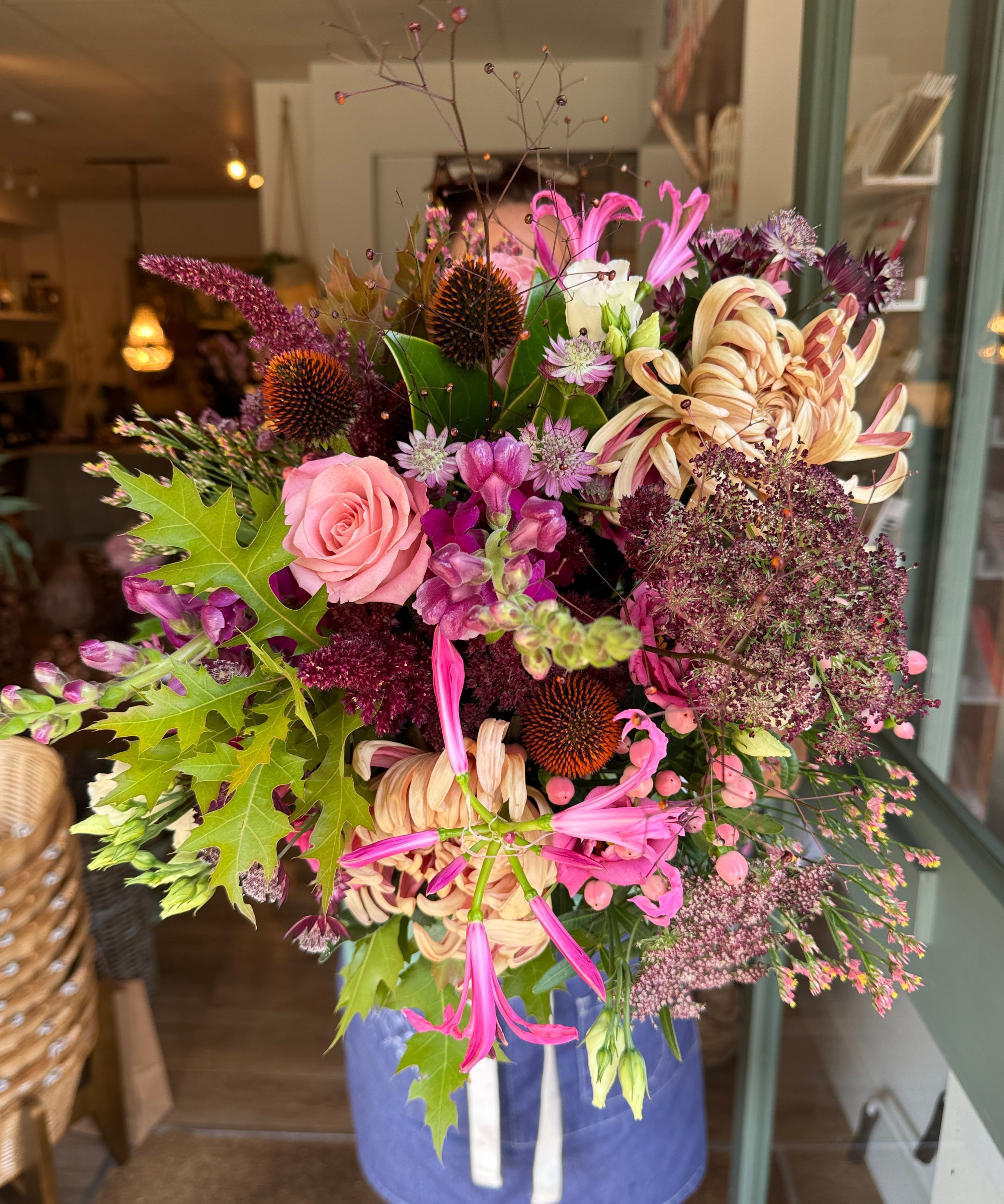 The Copper Hour luxury autumn flower bouquet featuring copper Vienna blooms, plum snapdragons, pink nerines, blue echinops, coral hypericum berries and autumn oak leaves.