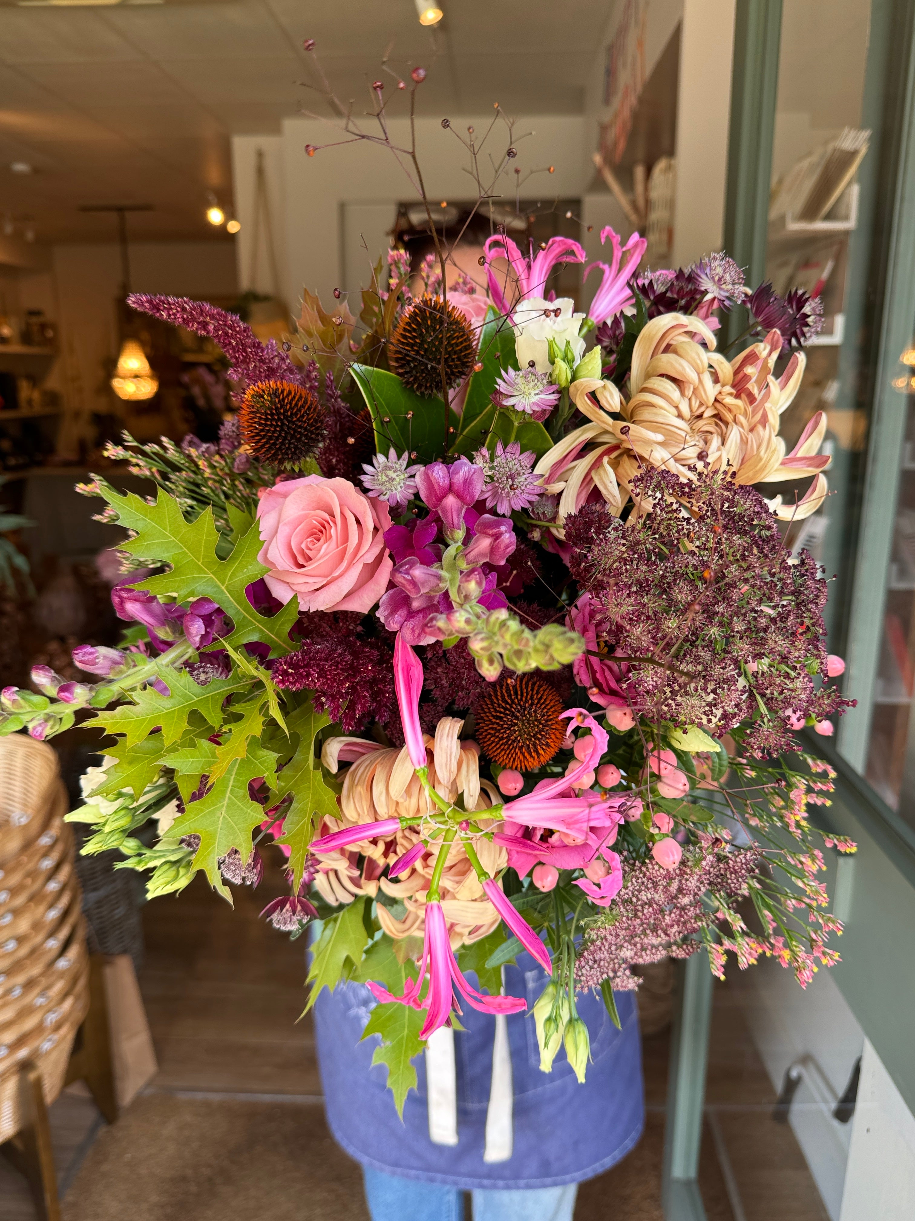 The Copper Hour luxury autumn flower bouquet featuring copper Vienna blooms, plum snapdragons, pink nerines, blue echinops, coral hypericum berries and autumn oak leaves.